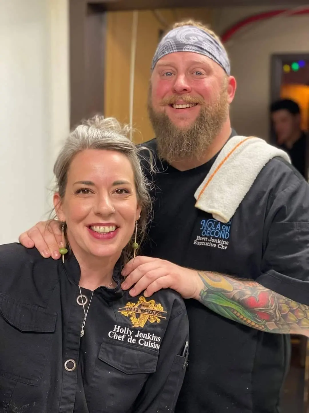 Brett and Holly Jenkins smiling in their chef jackets
