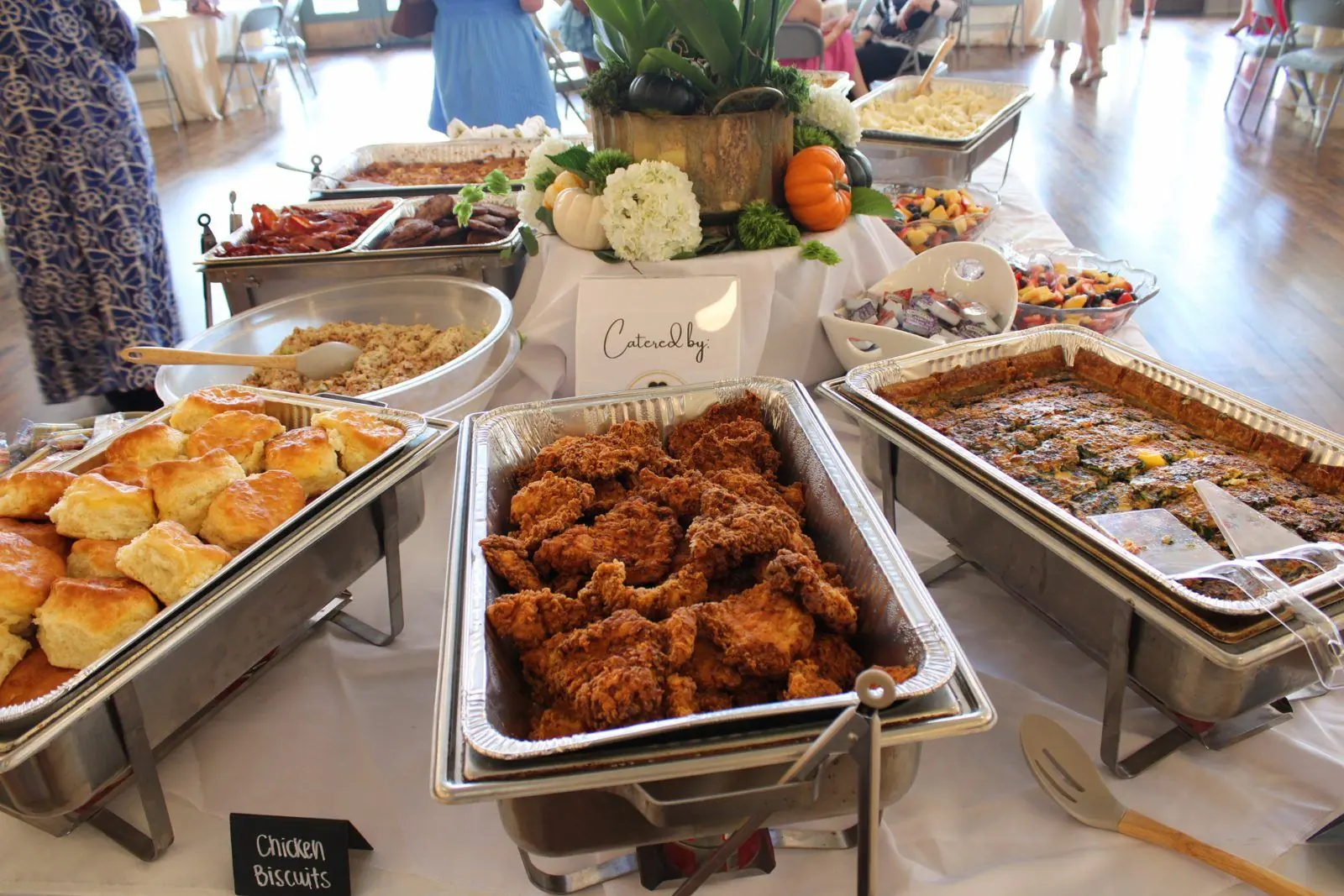 Nola's Clover catered brunch buffet with fried chicken, biscuits, quiche, bacon, and sausage in chafing dishes